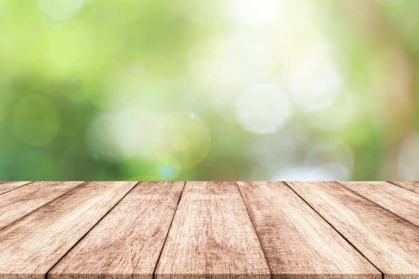 istock Wood table top on blur nature background with spring or summer 914034308