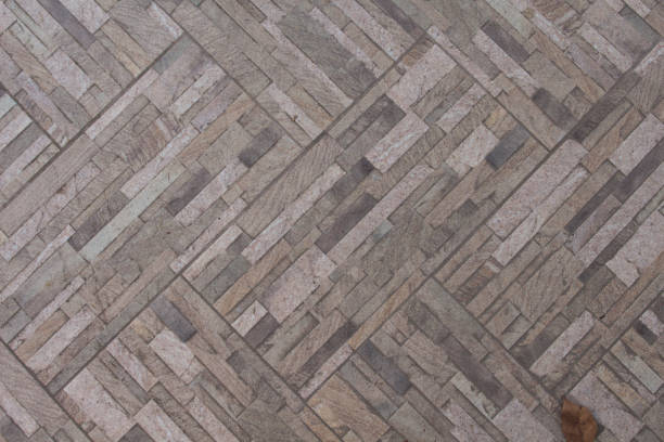 istock Stone paving texture with autumn leaf. Natural stone brick wall photo texture. 914034648