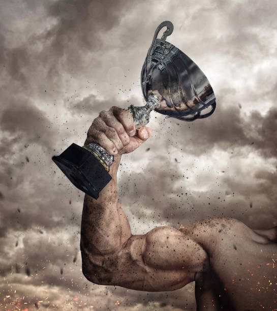 istock Cropped male arm with winner cup. 914035880