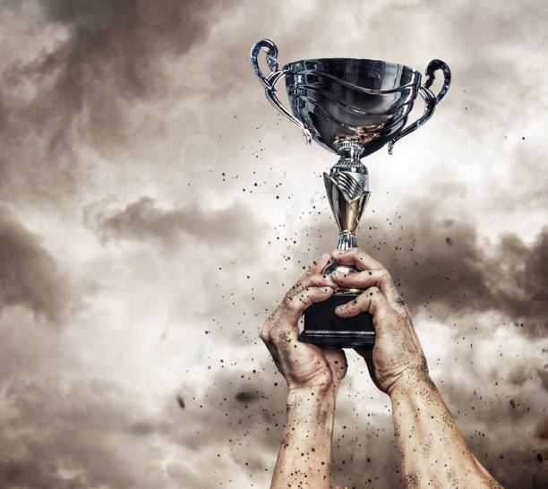 istock Cropped male arms with winner cup. 914038440