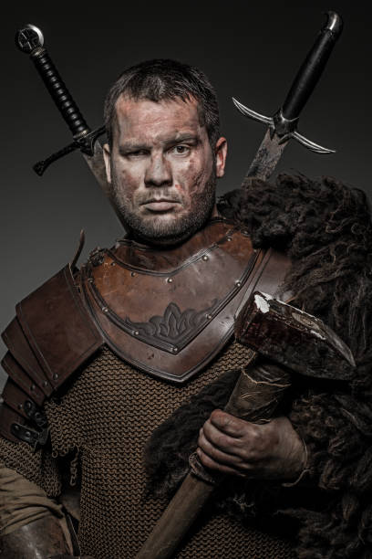 istock Weapon wielding viking warrior brunette male in studio shot 914038812