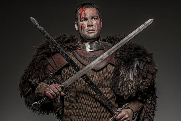 istock Weapon wielding viking warrior brunette male in studio shot 914039030