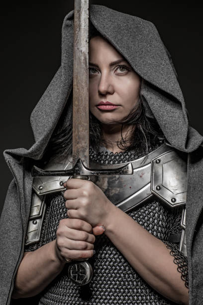 istock Sword wielding viking warrior brunette female in studio shot 914039046