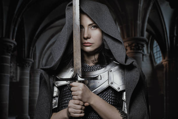 Sword wielding viking warrior dark haired female in wild highland countryside Sword wielding viking warrior dark haired female in wild highland countryside live action role playing photos stock pictures, royalty-free photos & images