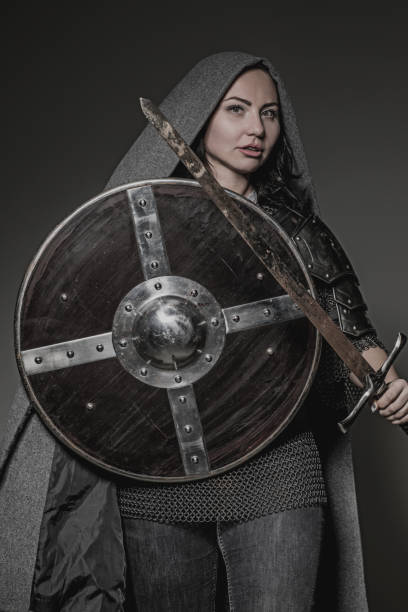 istock Sword wielding viking warrior brunette female in studio shot 914039068