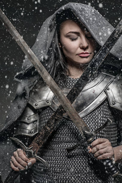 istock Sword wielding viking warrior brunette female in studio shot 914041182