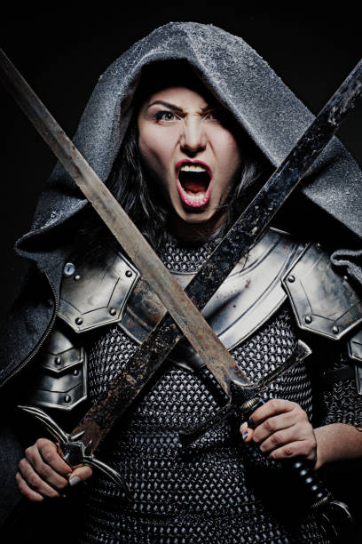 istock Sword wielding viking warrior brunette female in studio shot 914041202