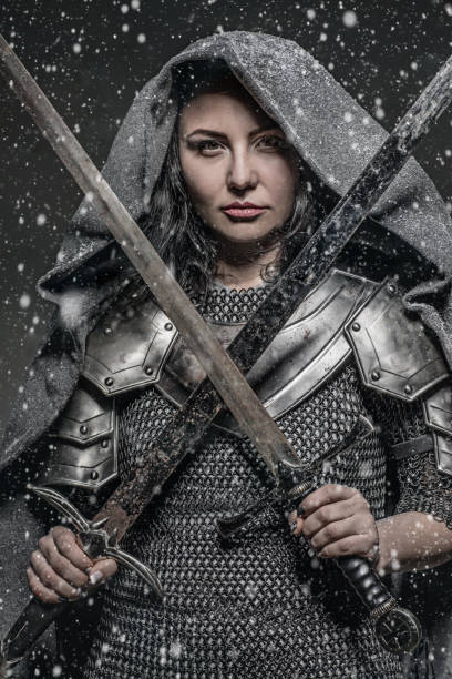 Sword wielding viking warrior brunette female in studio shot