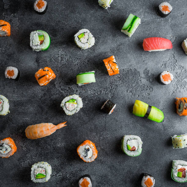 istock Pattern with sushi rolls on dark background. Japanese food. Flat lay. Top view 914041254