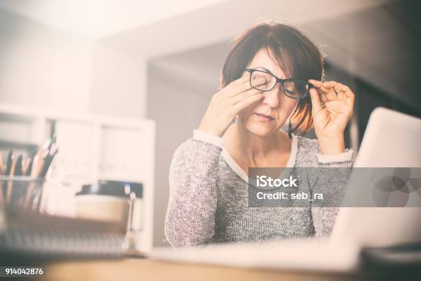 Tired Middle Age Woman Rubbing Eyes Stock Photo - Download Image Now - Tired, Rubbing Eyes, Mature Women