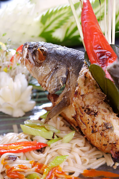 Fish head covered in chili peppers
