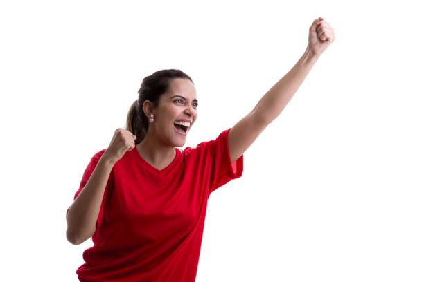 istock Female athlete / fan on red uniform celebrating on white background 914050276