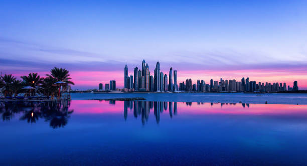 istock Dubai skyline with purple sky at sunset 914057158