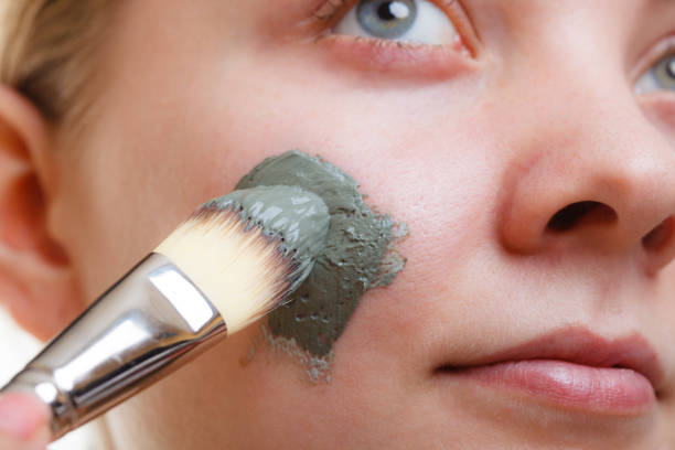istock Woman having mud green mask on her face 914058308