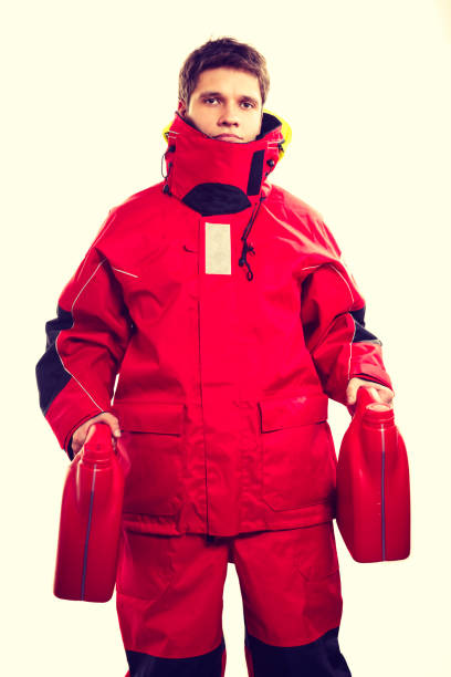istock Man in oilskin with bottle. 914058484