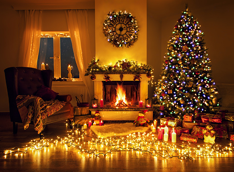 Interior of a modern lake house with fireplace and Christmas decorations in the winter.