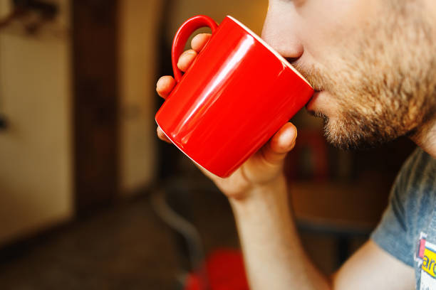 istock Man holding red cup of coffee in hand, close up 914059204