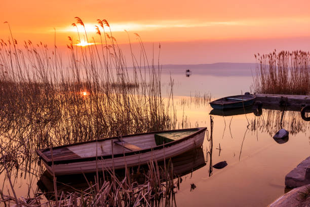 Sunset on the lake Balaton with a boat  in Hungary