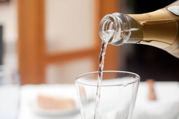istock Pouring white wine in wine glass. 914062582