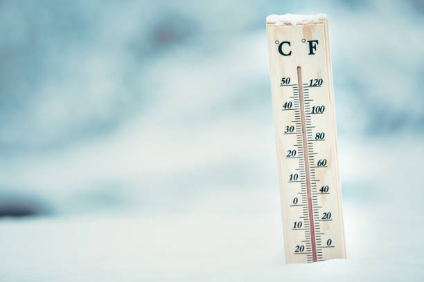 istock Wooden thermometer in the snow. Four degrees Celsius on the plus after snowfall. 914063062