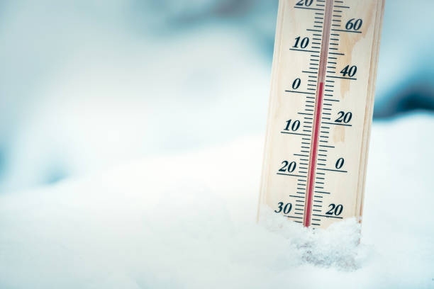 istock Wooden thermometer in the snow. Four degrees Celsius on the plus after snowfall. 914063070