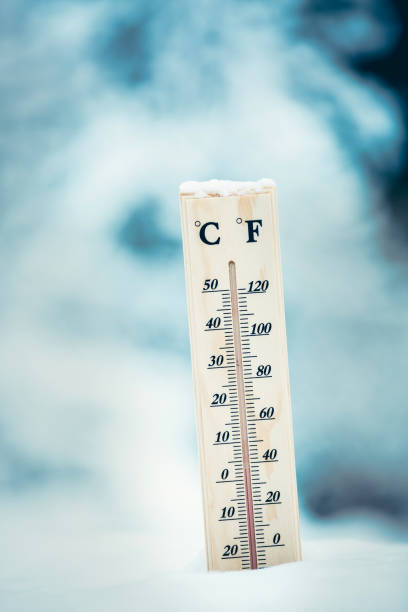 istock Wooden thermometer in the snow. Four degrees Celsius on the plus after snowfall. 914063090