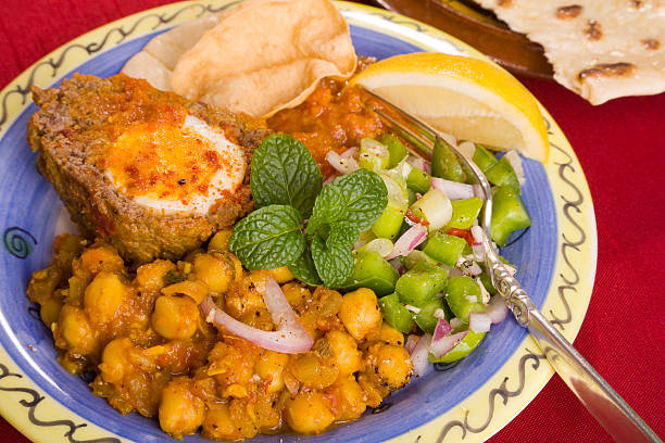 Potaje de garbanzos, chickpea stew spanish recipe vegetarian with spinach, potatoes and egg mediterranean diet on rustic wood
