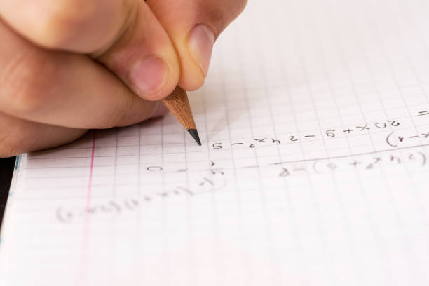 istock Writing in Notebook Close Up. Pencil in Children Hand. 914070094