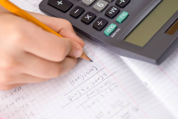 istock Writing in Notebook Close Up. Pencil in Children Hand. 914070166