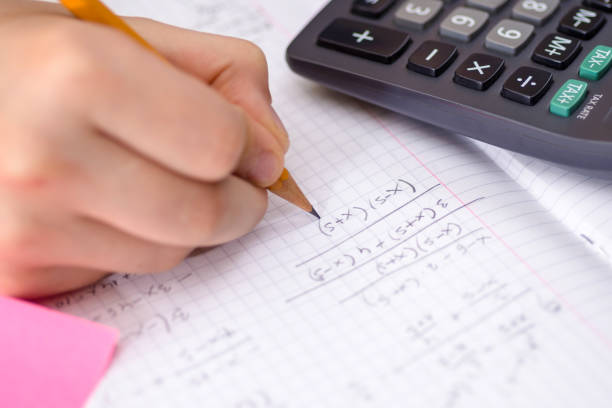istock Writing in Notebook Close Up. Pencil in Children Hand. 914070258