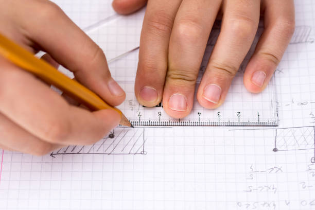 istock Schoolboy Hands with Ruler Drawing on White Paper. Mathematics Concept. 914070448