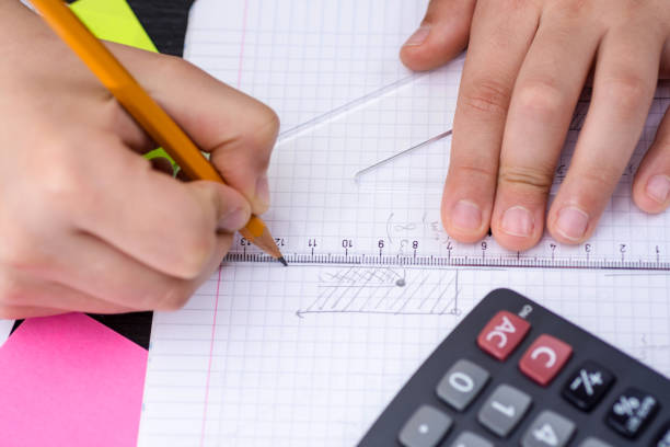istock Schoolboy Hands with Ruler Drawing on White Paper. Mathematics Concept. 914070498