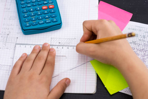 Schoolboy Hands with Ruler Drawing on White Paper. Mathematics Concept.