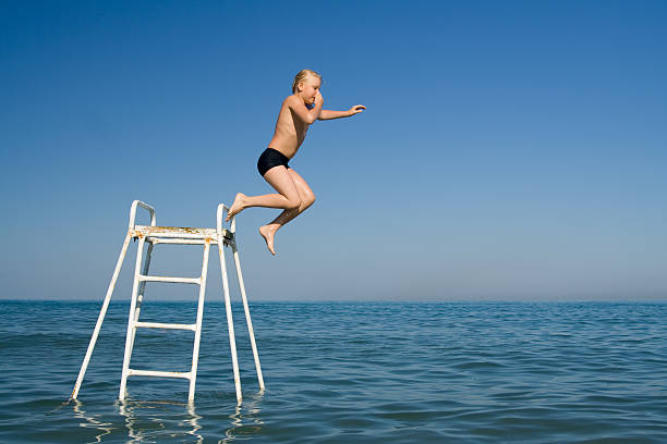istock Boy jumping in the water 91407722