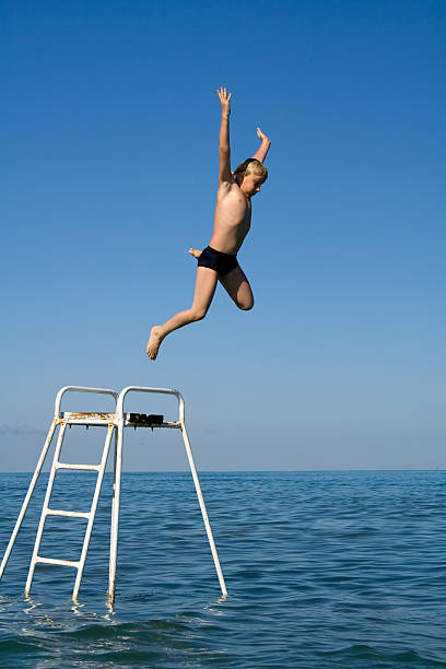 istock Boy jumping in the water 91407724