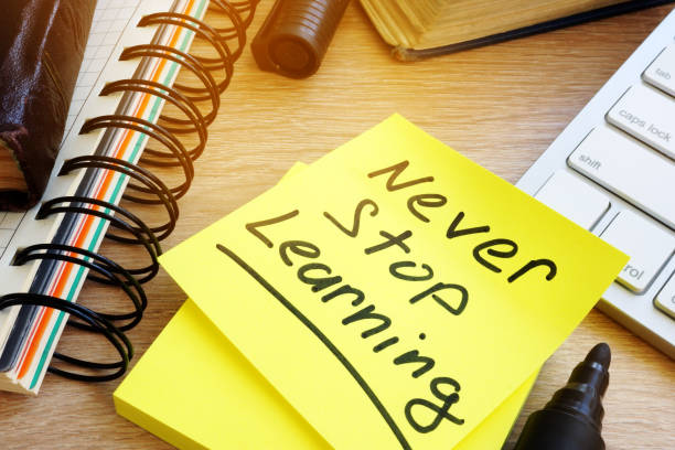 Never stop learning written on a stick. Lifelong learning concept. Never stop learning written on a memo stick. Lifelong learning concept. mature student stock pictures, royalty-free photos & images