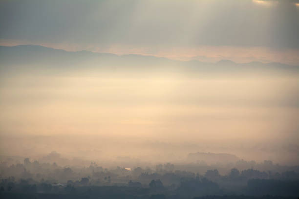 beautiful sunrise landscape with mist and sun lighting stock photo