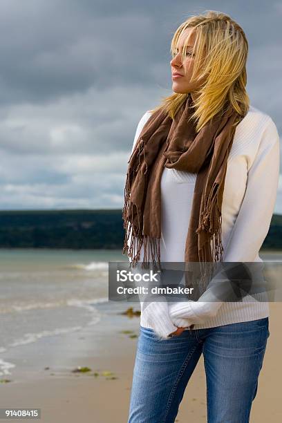 Windswept Thoughtful Beautiful Young Woman On Stormy Beach Stock Photo - Download Image Now