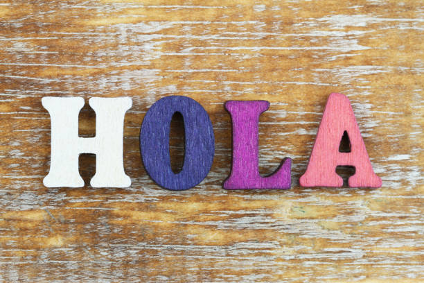 istock Word hola (which means hello in Spanish) written with colorful letters on wooden surface 914085014