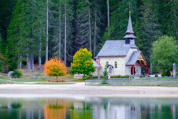 Photo of Little chapel at the Braies Lake in Dolomites mountains