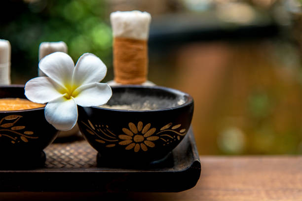 Two Thai massage therapists doing a massage for two female clients.
