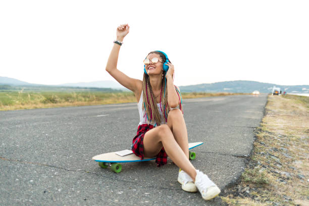 istock Beautiful woman using smart phone on country road 914094152