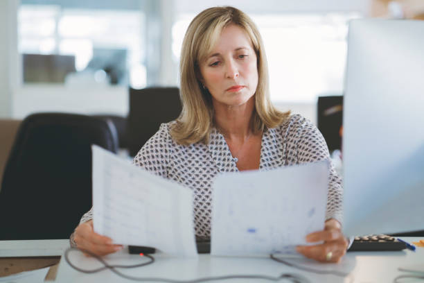 istock Businesswoman reading documents in office 914094226