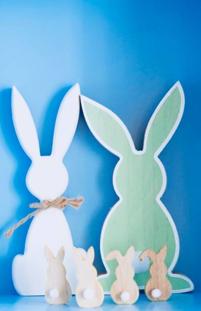 istock Easter rabbit family rear view on blue background 914104714