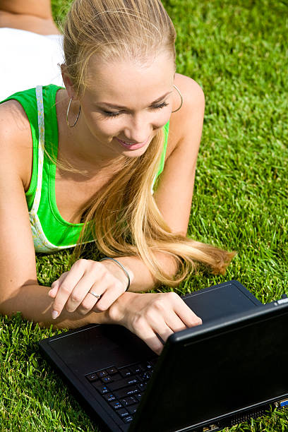 istock Girl with laptop on the grass 91411239