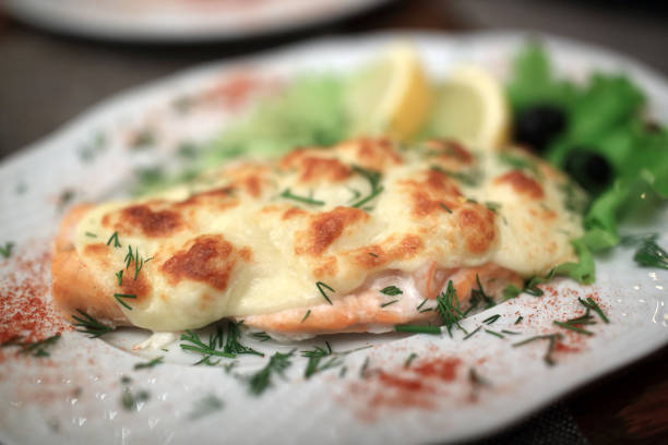 Baked salmon steak with suluguni cheese in restaurant