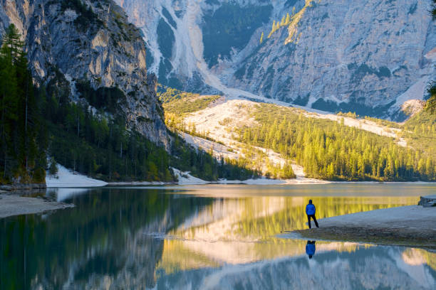 istock Man Traveler standing alone  Braies Lake 914121458