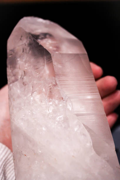 istock Hand holding mountain crystal berg clear quartz 914122996