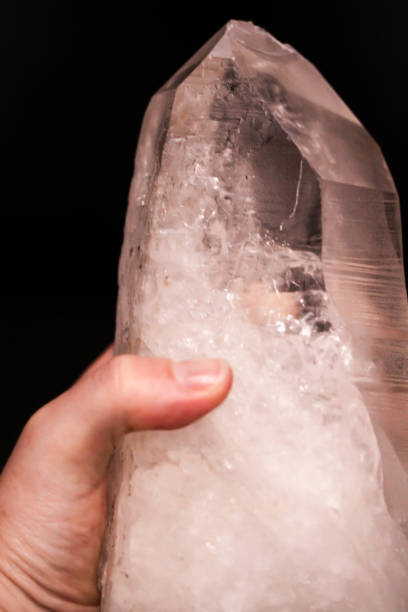 istock Hand holding mountain crystal berg clear quartz 914123042