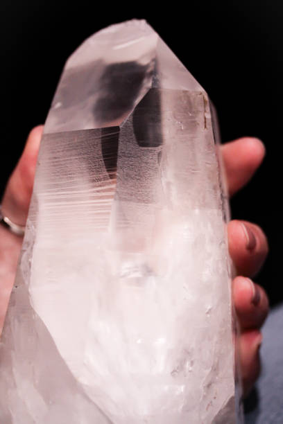 istock Hand holding mountain crystal berg clear quartz 914123062
